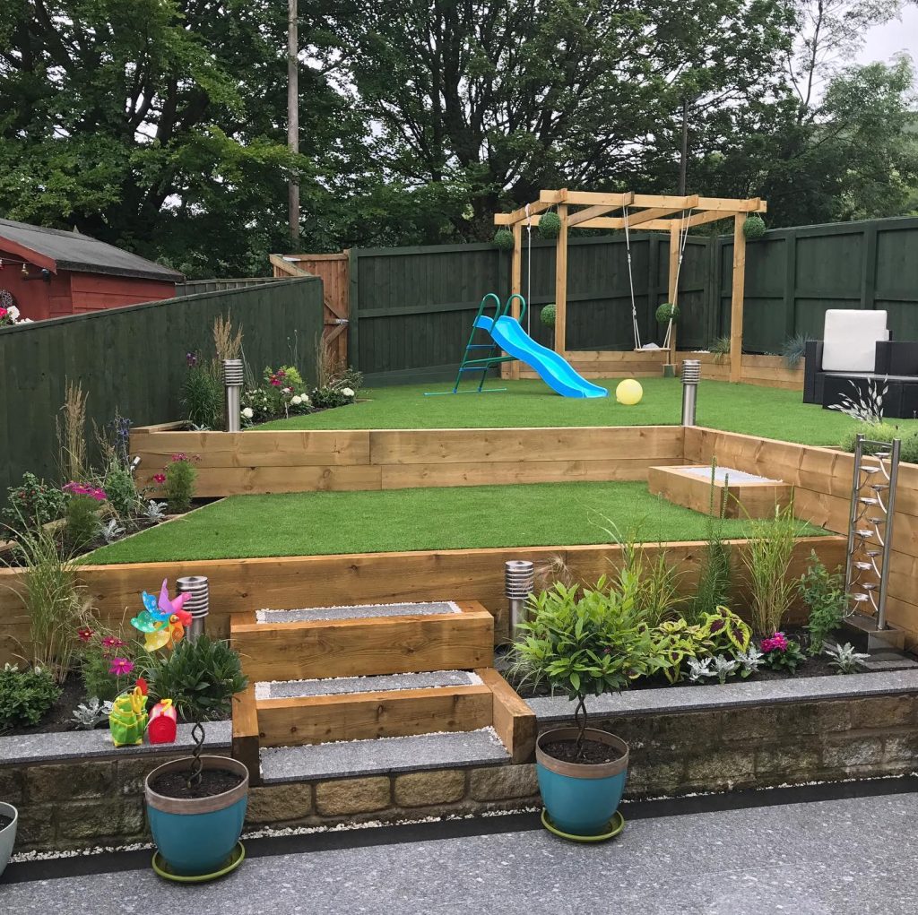 Completed multi-level family garden with lawn, raised beds and timber steps